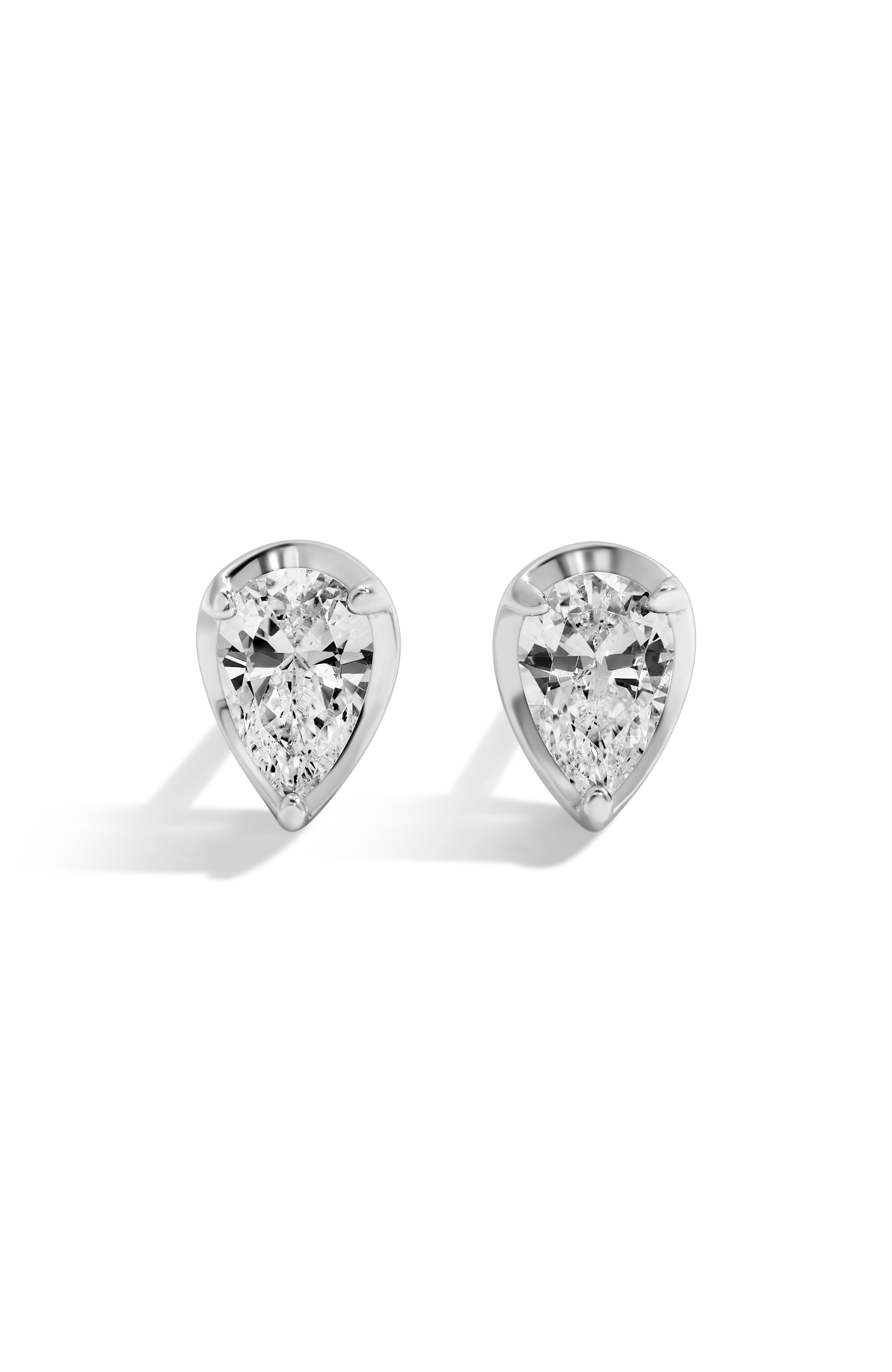 Pair of pear-shaped diamond stud earrings on a white background